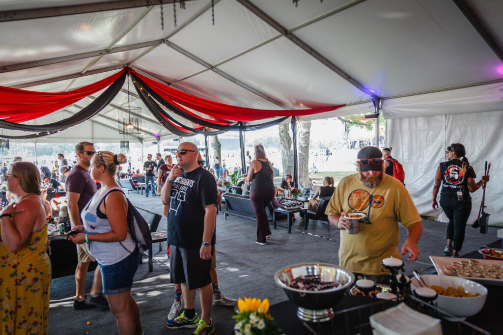 Deluxe shaded tent with buffet line at Riot Fest