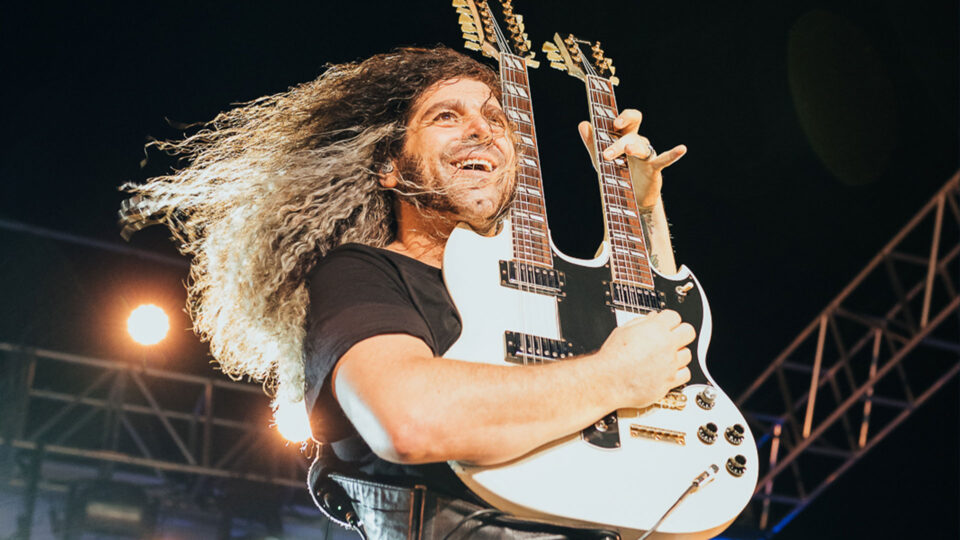 Claudio Sanchez of Coheed and Cambria playing a guitar